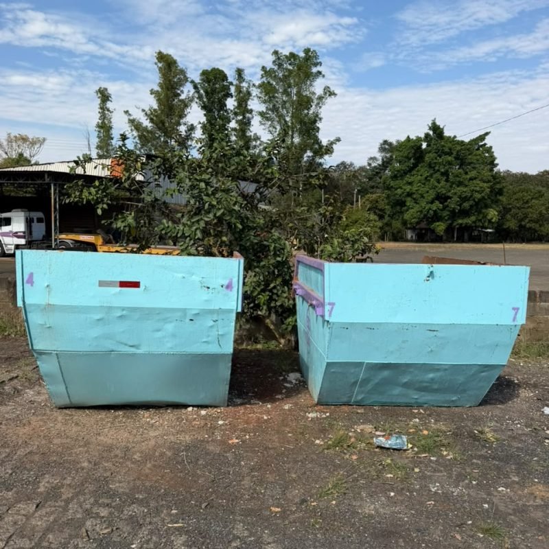Duas caçambas da ECO-TSA posicionadas lado a lado no pátio